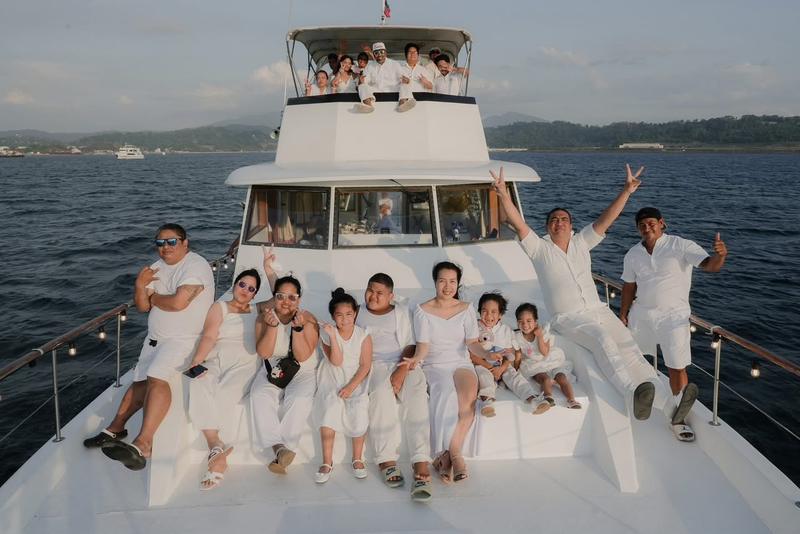 Group of friends on the bow of a yacht